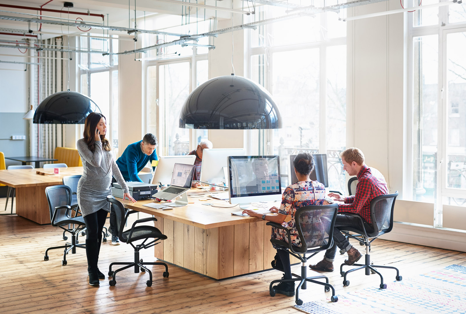 co workers working in start up office